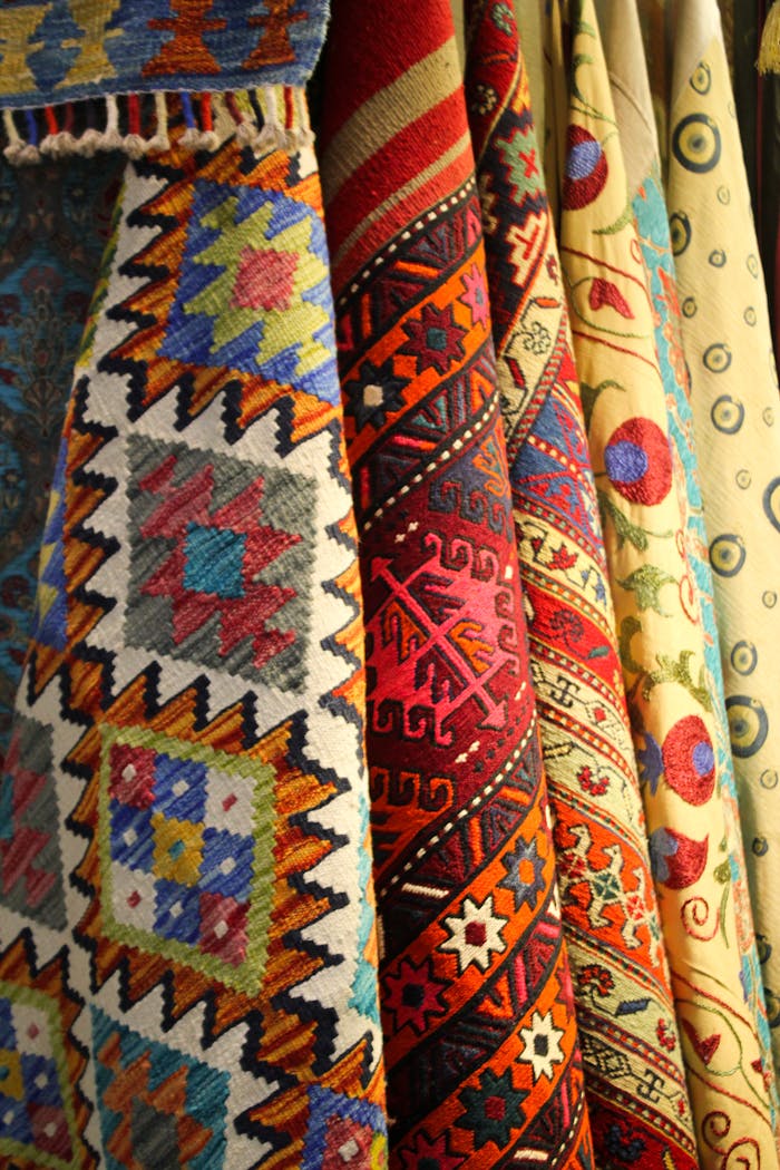 journey A vibrant array of traditional woven textiles showcasing intricate patterns and bold colors.