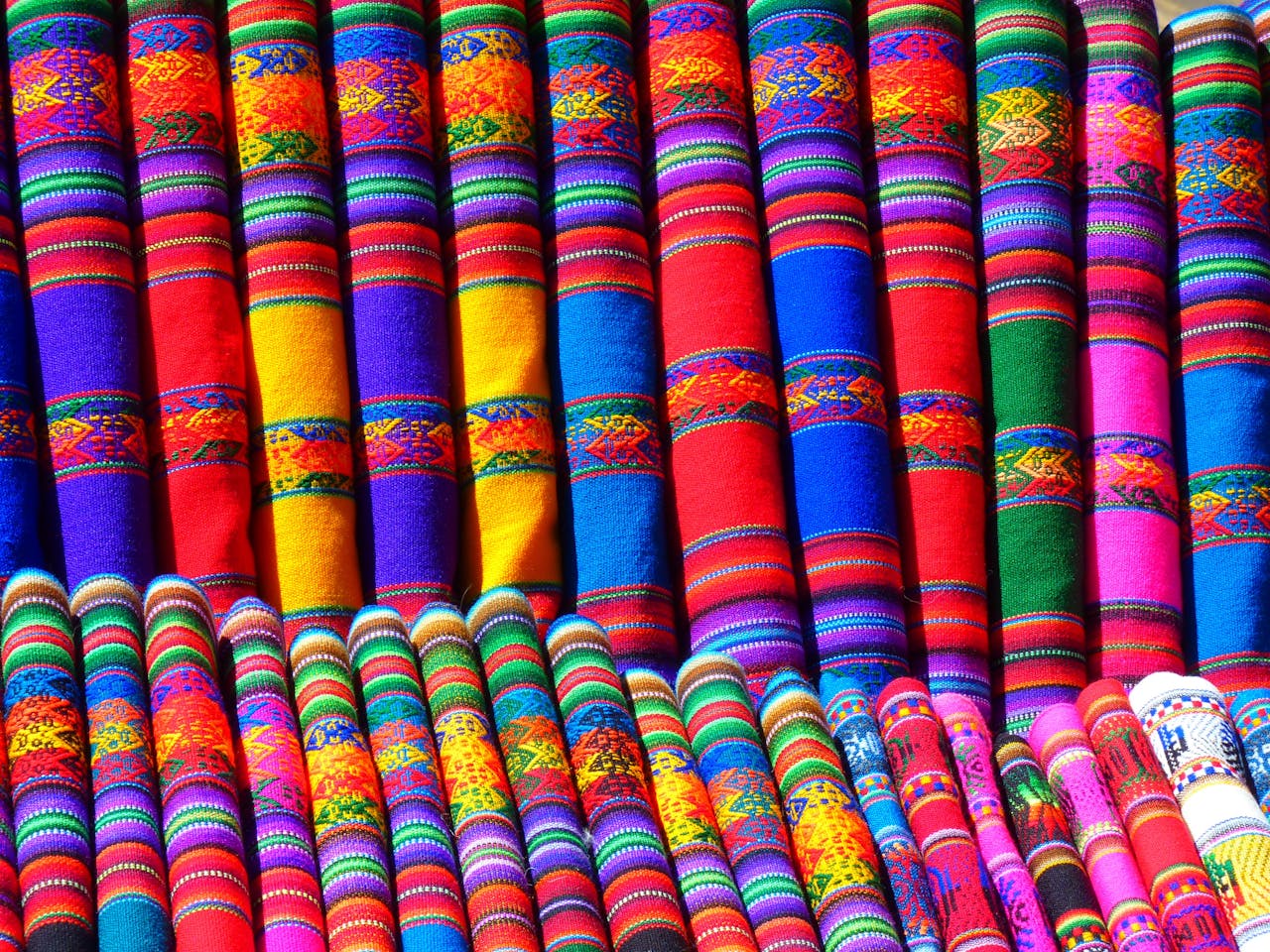 why-choose-us Colorful traditional textiles showcasing intricate geometric patterns and rich cultural heritage.